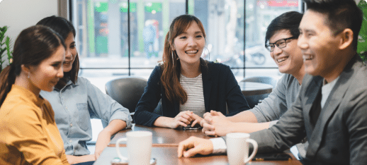 Smiling professionals in a team meeting, representing collaboration and teamwork in a business setting