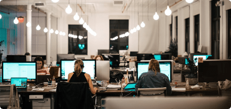 Several people working together in an office, illustrating multi-country payroll solutions